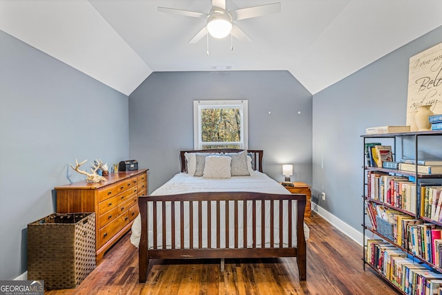 bedroom with vaulted ceiling, ceiling fan, and dark hardwood / wood-style floors