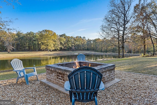 view of yard with a water view and an outdoor fire pit