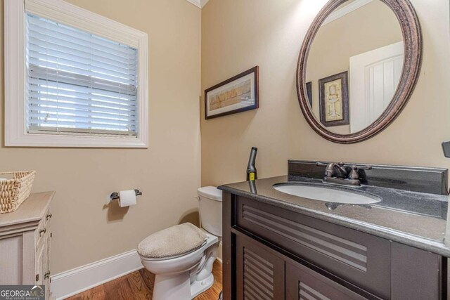 bathroom featuring hardwood / wood-style floors, vanity, and toilet