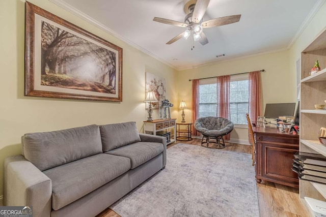 living room featuring light hardwood / wood-style floors, ceiling fan, and ornamental molding