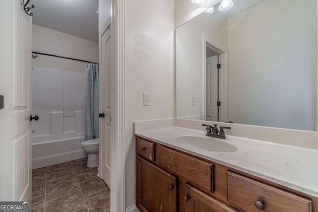 full bathroom featuring vanity, shower / bath combo, and toilet