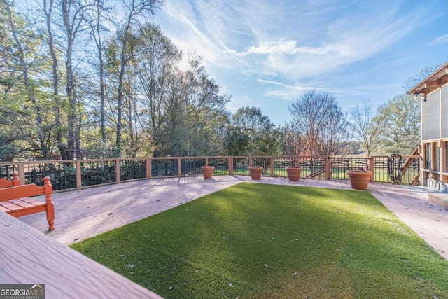 view of yard featuring a wooden deck and a patio area