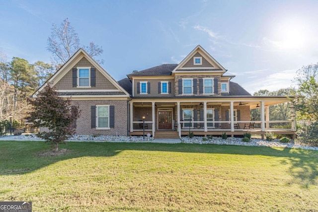 view of front of property featuring covered porch and a front lawn