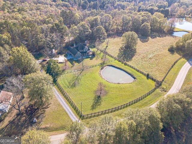 birds eye view of property with a water view and a rural view