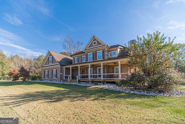 view of front of home with ceiling fan, a front lawn, and a porch