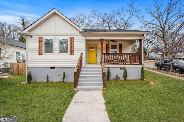 bungalow-style house with ceiling fan, a front lawn, and a porch