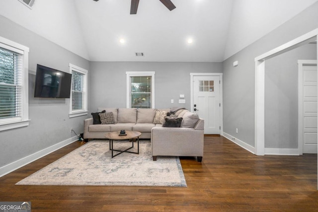 living room with ceiling fan, dark wood-type flooring, and vaulted ceiling