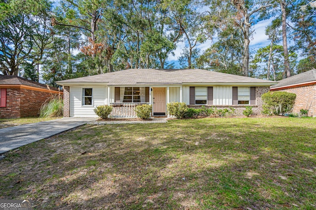 ranch-style house with covered porch and a front lawn