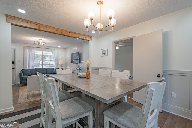 115 Lucian Cir, Savannah, GA 31406 - dining space featuring a chandelier, a textured ceiling, wood finished floors, a decorative wall, and wainscoting