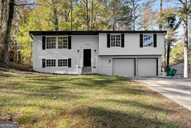 raised ranch featuring a front yard and a garage