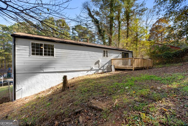 back of house with a wooden deck