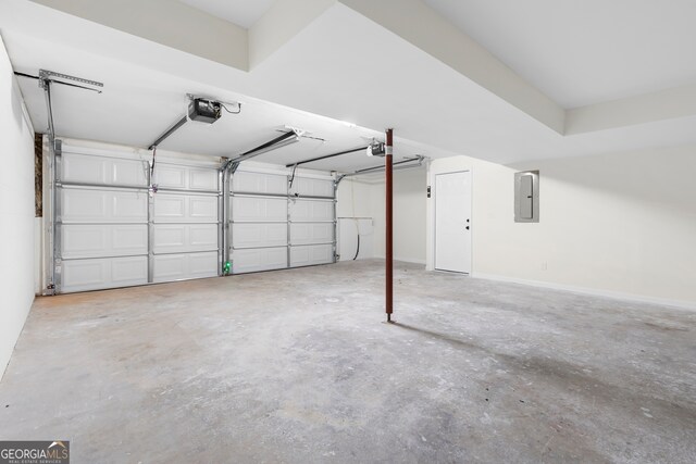 garage with electric panel and a garage door opener