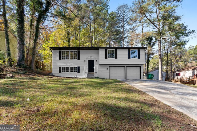 split foyer home with a front lawn and a garage