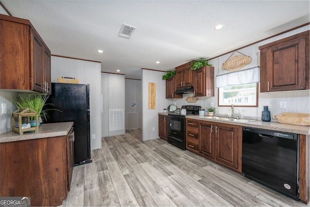 kitchen featuring sink, light hardwood / wood-style floors, black appliances, crown molding, and a textured ceiling