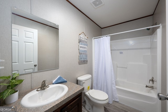 full bathroom with shower / tub combo with curtain, hardwood / wood-style flooring, vanity, toilet, and crown molding