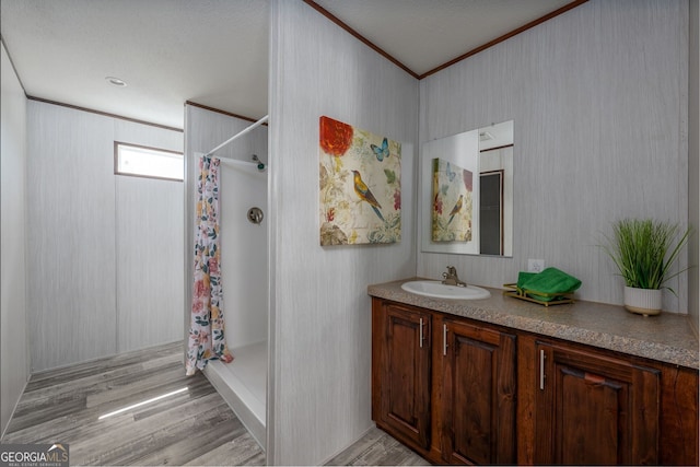 bathroom with hardwood / wood-style flooring, vanity, ornamental molding, and a shower with shower curtain