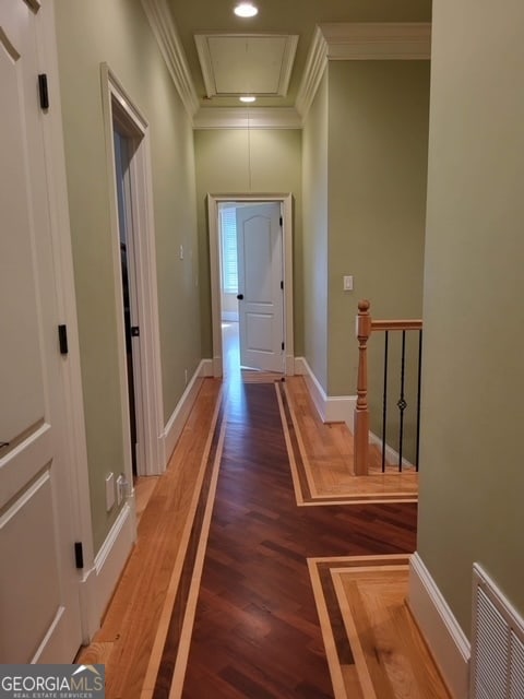 hall featuring hardwood / wood-style flooring and ornamental molding