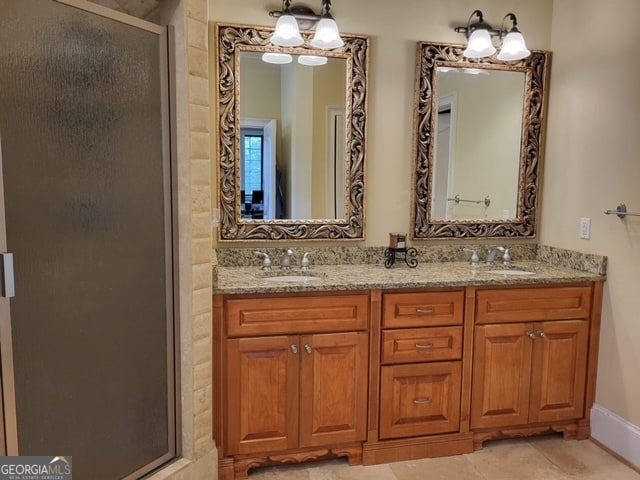 bathroom featuring tile patterned floors, vanity, and walk in shower