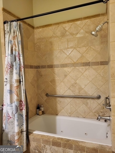 bathroom with shower / bath combo with shower curtain