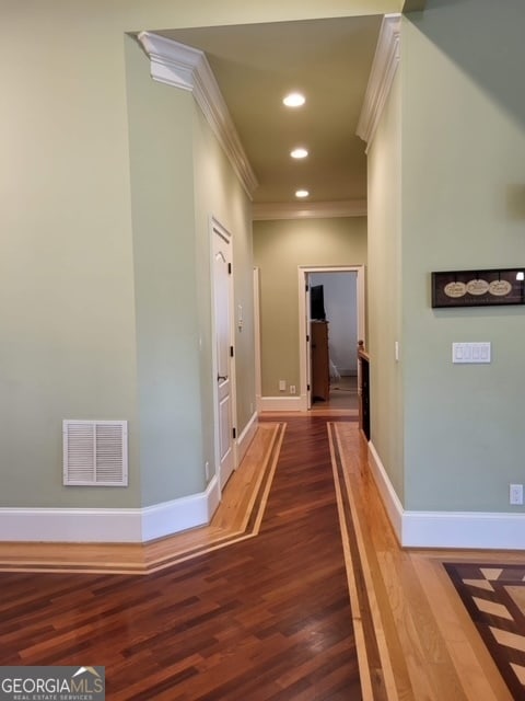 corridor featuring hardwood / wood-style floors and crown molding