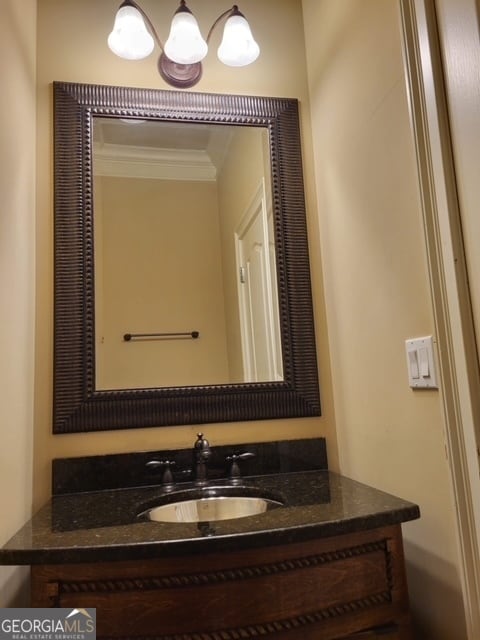 bathroom with vanity and ornamental molding