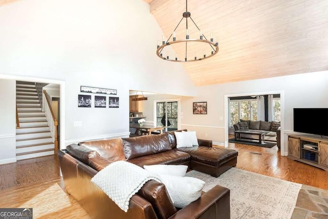 living room featuring a chandelier, high vaulted ceiling, wood ceiling, and light wood-type flooring