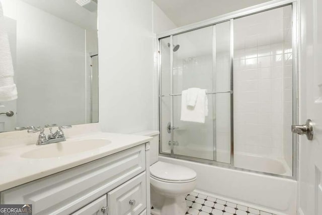 full bathroom featuring vanity, toilet, and bath / shower combo with glass door