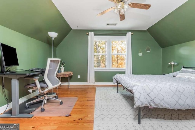 bedroom with hardwood / wood-style flooring, ceiling fan, and lofted ceiling