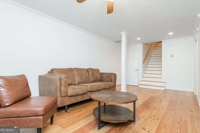 living room featuring ceiling fan, light hardwood / wood-style floors, and ornamental molding