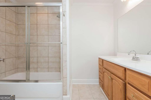 bathroom featuring tile patterned flooring, vanity, bath / shower combo with glass door, and crown molding