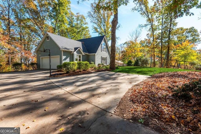 view of home's exterior with a yard and a garage