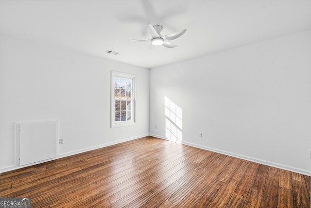 spare room with hardwood / wood-style flooring and ceiling fan