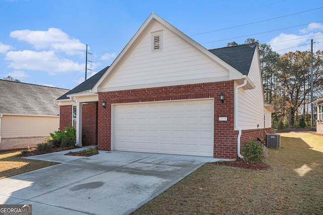 view of front of house featuring central air condition unit, a front yard, and a garage