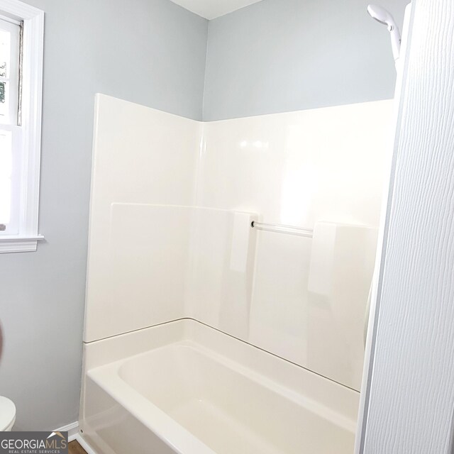 bathroom featuring  shower combination