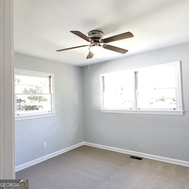 unfurnished room with carpet flooring and ceiling fan