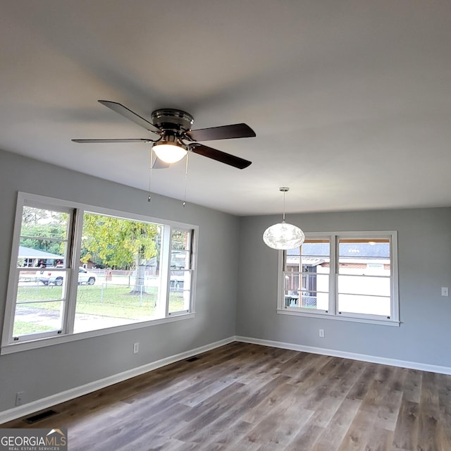 unfurnished living room featuring light hardwood / wood-style flooring and ceiling fan