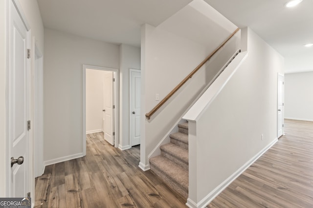 staircase with wood-type flooring