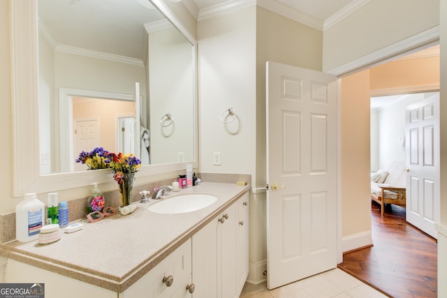 bathroom with vanity, wood-type flooring, and ornamental molding