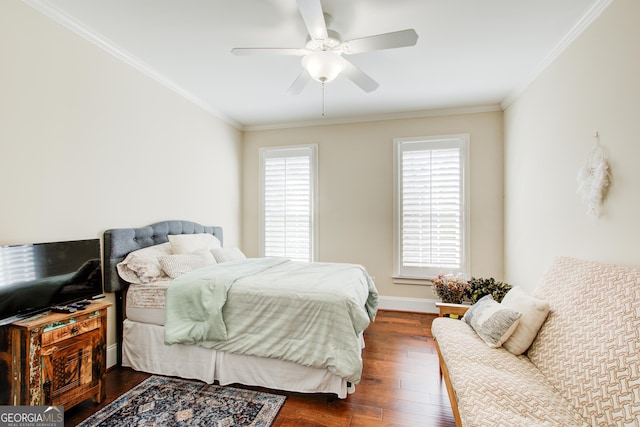 bedroom featuring ornamental molding, ceiling fan, and dark wood-type flooring