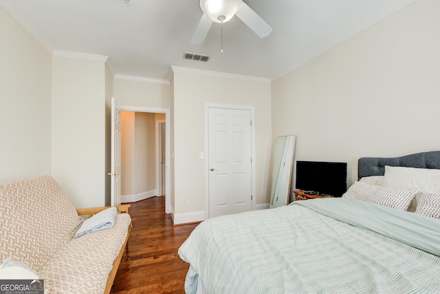 bedroom featuring dark hardwood / wood-style floors, ceiling fan, and crown molding