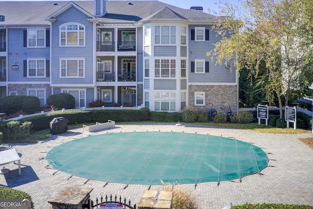 view of pool featuring a patio area and central AC