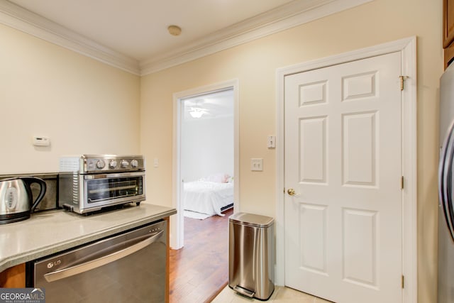 kitchen featuring light wood-type flooring, crown molding, and appliances with stainless steel finishes