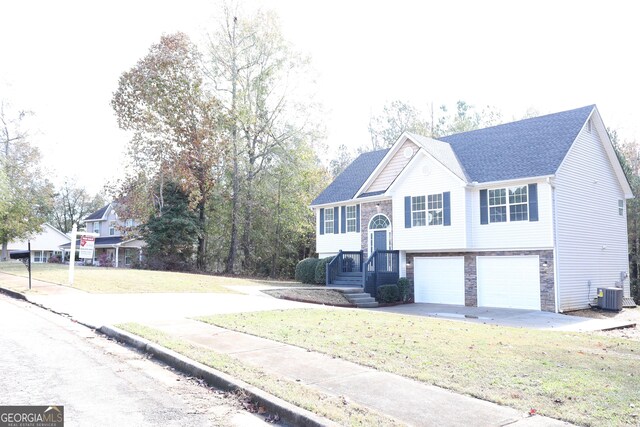 split foyer home with a front yard and a garage