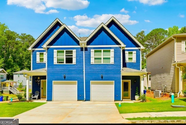 view of front of property featuring central AC unit, a garage, and a front yard