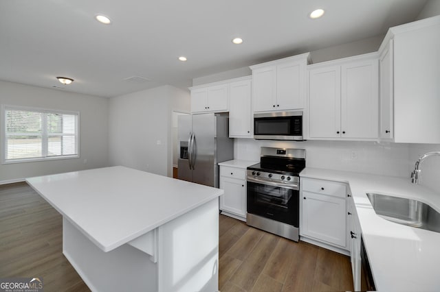 kitchen featuring a center island, white cabinetry, sink, and appliances with stainless steel finishes