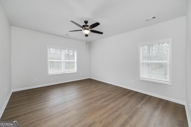 spare room featuring hardwood / wood-style floors and a healthy amount of sunlight