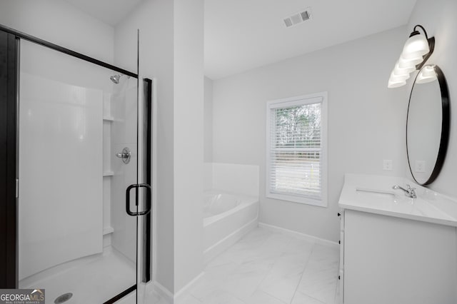 bathroom featuring vanity and independent shower and bath