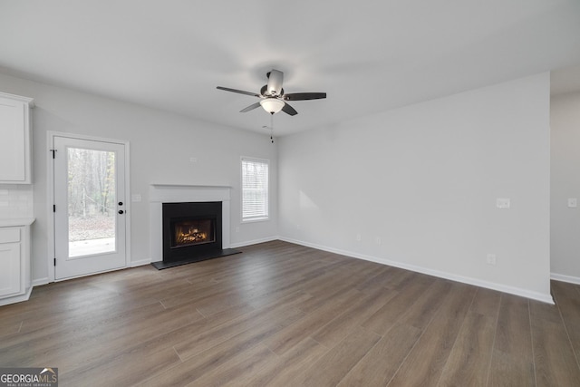 unfurnished living room featuring ceiling fan and light hardwood / wood-style flooring