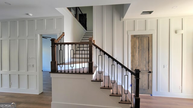 stairway with hardwood / wood-style floors