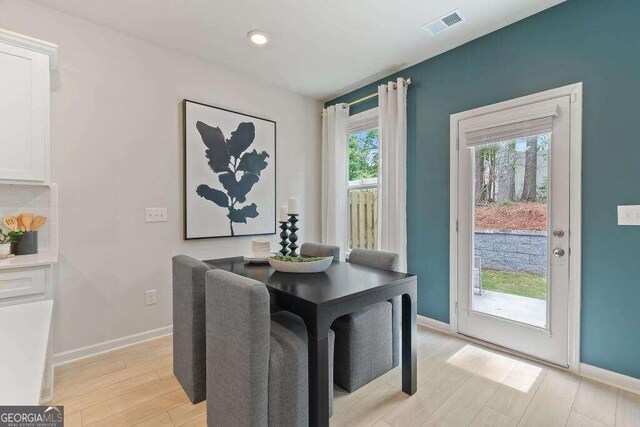 dining space featuring light wood-type flooring